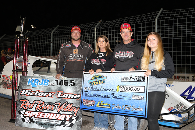 Austin Arneson in victory lane with the Todd Sanders family of Sanders Metal Products